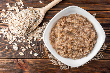 Rye porridge on dark wooden background.