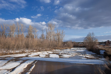 Fototapeta premium Spring landscape river, forest and clouds on a blue sky