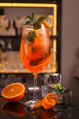 Barmen is making Aperol Spritz cocktail.  Alcohol cocktail on black background surface