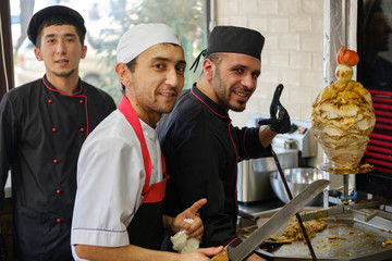 Man at the kitchen cook kebab