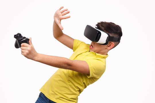 Shocked boy with controller evading danger in virtual reality
