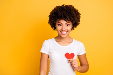 Close up photo beautiful amazing she her dark skin lady healthy heart safety message paper shape figure postcard lovely wear casual white t-shirt isolated yellow bright vibrant background