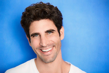 Smiling guy on blue background, portrait