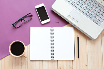 Business, Finance or work day concept : Top view or flat lay of office table desk work space with blank notebook, smart phone, computer laptop and coffee ready for adding or mock up