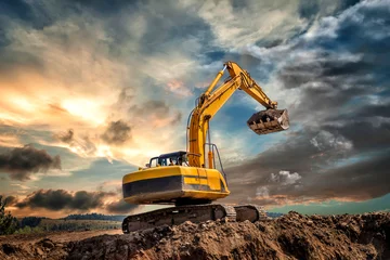 Fotobehang Crawler excavator during earthmoving works on construction site at sunset © EdVal