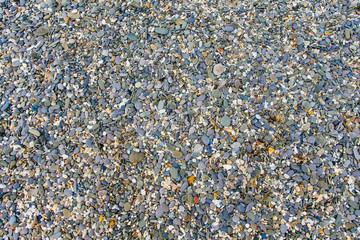 Stone texture. Colorful pebbles lying on beach background
