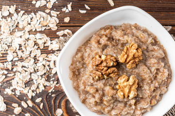 Rye porridge on dark wooden background.