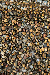 Stone pebbles on the seashore as an abstract background