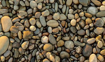 Stone pebbles on the seashore as an abstract background