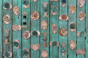 vintage glass door handles on old wooden turquoise boards, top view