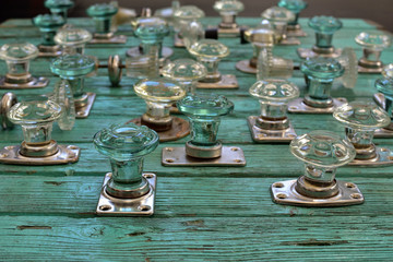 collection of vintage glass door handles on an old wooden turquoise table