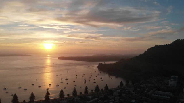 4k aerial mout manganui sunset camer dolly back