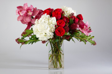 bouquet of roses in vase on white background