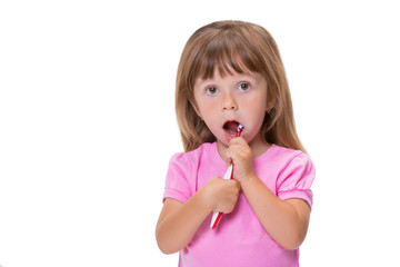Close-up portrait Cute little girl 3 year old in pink t-shirt brushing her teeth isolated on white background