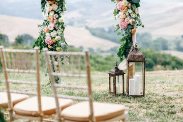 Italian wedding decoration. Green eucalyptus, oranges and pink flowers decorate wedding altar