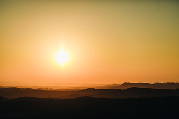 Sun goes down over the fields of Italian Tuscany