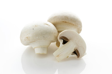 Fototapeta na wymiar White champignon mushrooms on a white background