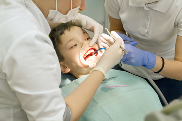 Orthodontist examining boy mouth