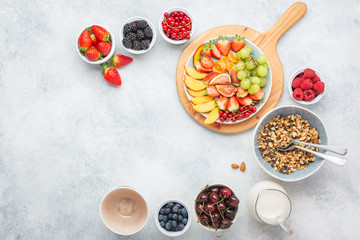 Raw vegan paleo granola made with nuts served with berries on white, top view, copy space