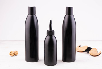 Black bottles from under shampoo, oil and the conditioner with the men accessories