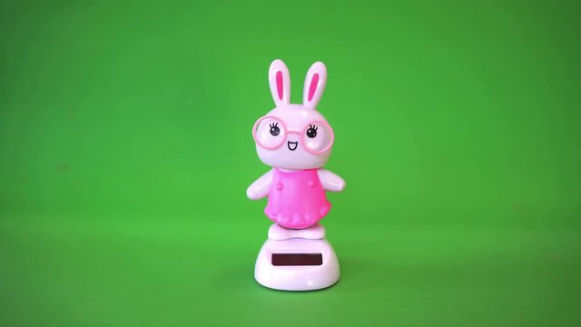 Rabbit doll dancing on green screen background.