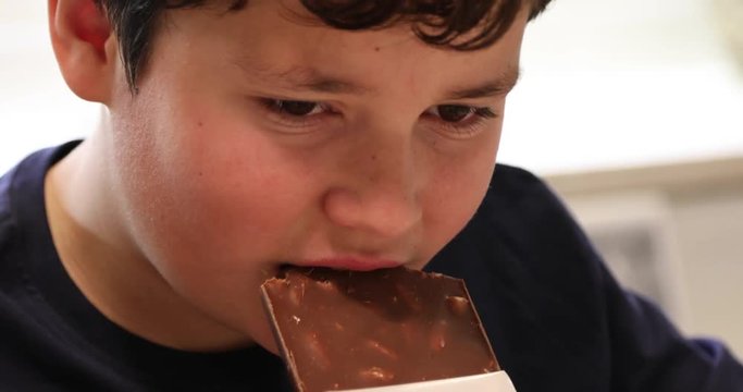 Child eating chocolate in the kitchen 2