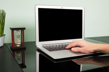 Fototapeta na wymiar workplace with laptop on black table