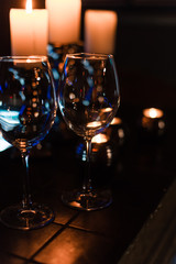 empty wine glasses and candles with illumination lights background. Romantic dinner dating night in bar or restaurant . 