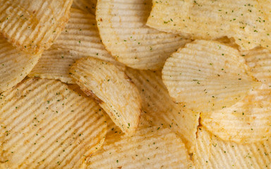 potato chips with herbs and pepper. background