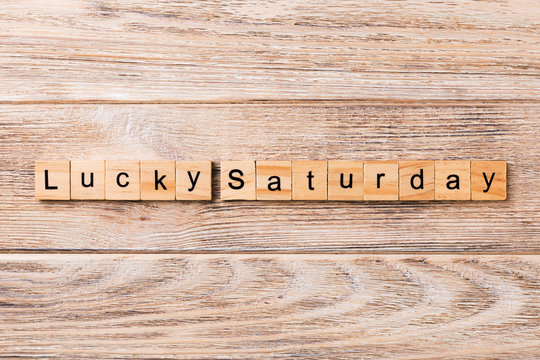lucky saturday word written on wood block. lucky saturday text on wooden table for your desing, concept