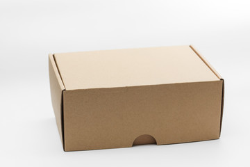 Closed empty cardboard box isolated on a white background