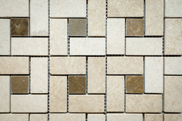 Obraz premium Mosaic of beige and brown marble in the form of squares and rectangles.