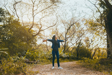 Young Asian female tourists relax in the hikes of the fine weather on weekends, with a happy ukulele alone.