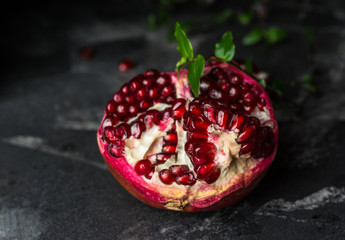 Ripe pomegranate fruit on black background. Vegetarian. Vitamin. Healthy food. Diet food.