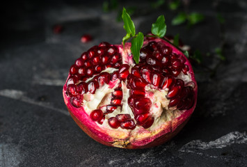 Ripe pomegranate fruit on black background. Vegetarian. Vitamin. Healthy food. Diet food.