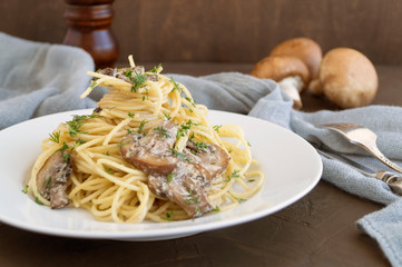 Spaghetti with mushrooms in cream sauce. on dark background