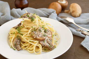 Spaghetti with mushrooms in cream sauce. on dark background