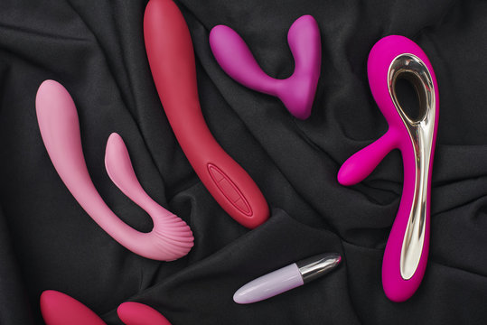 Adult gifts for couples. Close up photo of colorful various sex toys: dildos prostate massager, g-spot vibrators and others.