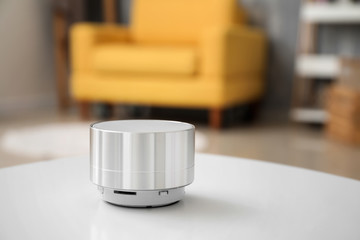 Smart home assistant device on table in room