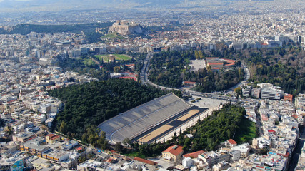 Aerial drone photo of iconic ancient Panathenaic stadium or Kalimarmaro as seen from distance and Acropolis hill, Zappeion at the background, Athens historic centre, Attica, Greece