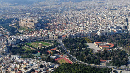 Fototapeta premium Aerial drone photo of iconic ancient Panathenaic stadium or Kalimarmaro as seen from distance and Acropolis hill, Zappeion at the background, Athens historic centre, Attica, Greece