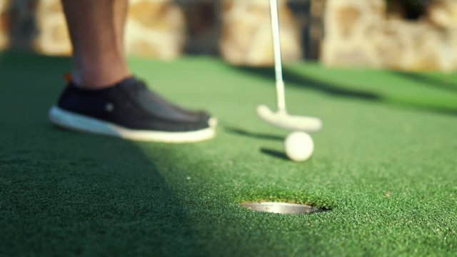Man swinging golf cub and hitting a ball in 4k slow motion 60fps