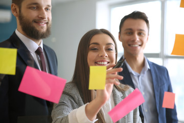 View at business team during meeting in office through transparent board