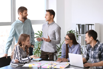 Group of people discussing business plan in office