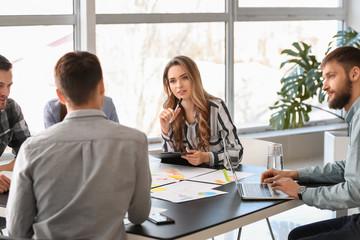 Group of people discussing business plan in office
