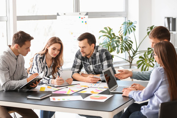 Group of people discussing business plan in office