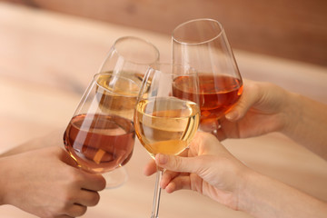 Women clinking glasses with tasty wine, closeup