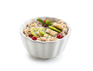 Bowl with tasty oatmeal on white background