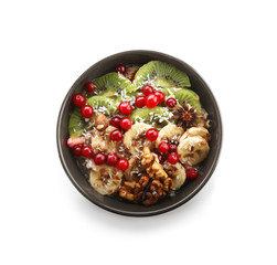 Bowl with tasty oatmeal on white background