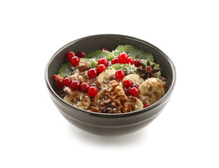 Bowl with tasty oatmeal on white background